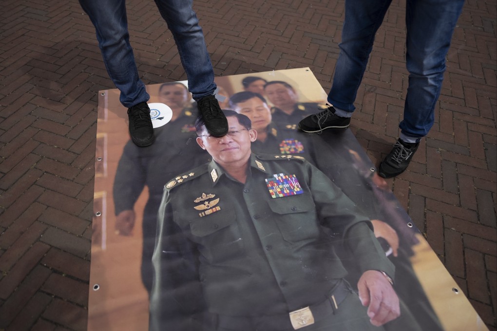 Pro-Rohingya demonstrators stomp on an image of Myanmar military governor General Min Aung Hlaing, outside the International Court of Justice in The Hague, Netherlands, Friday. Photo: AP