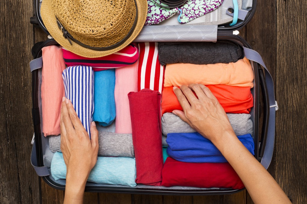 Rolling rather than folding clothes saves space if you are trying to pack all your holiday needs in carry-on bag to avoid checked baggage being lost or delayed at understaffed airports this summer. Photo: Shutterstock