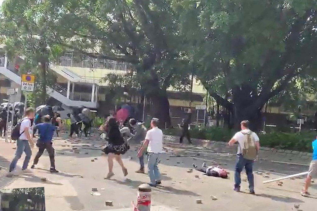 Luo Changqing, 70, lies on the road after being hit with a brick during a demonstration outside the Sheung Shui MTR station in 2019. Photo: Handout