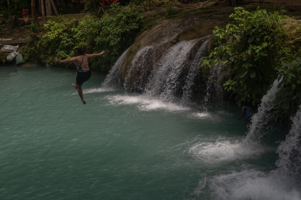 A woman jumps from the Cambugahay Falls, a popular tourist spot, in Siquijor, a Philippine Island that does not allow the use of plastics.
Photo: Geela Garcia