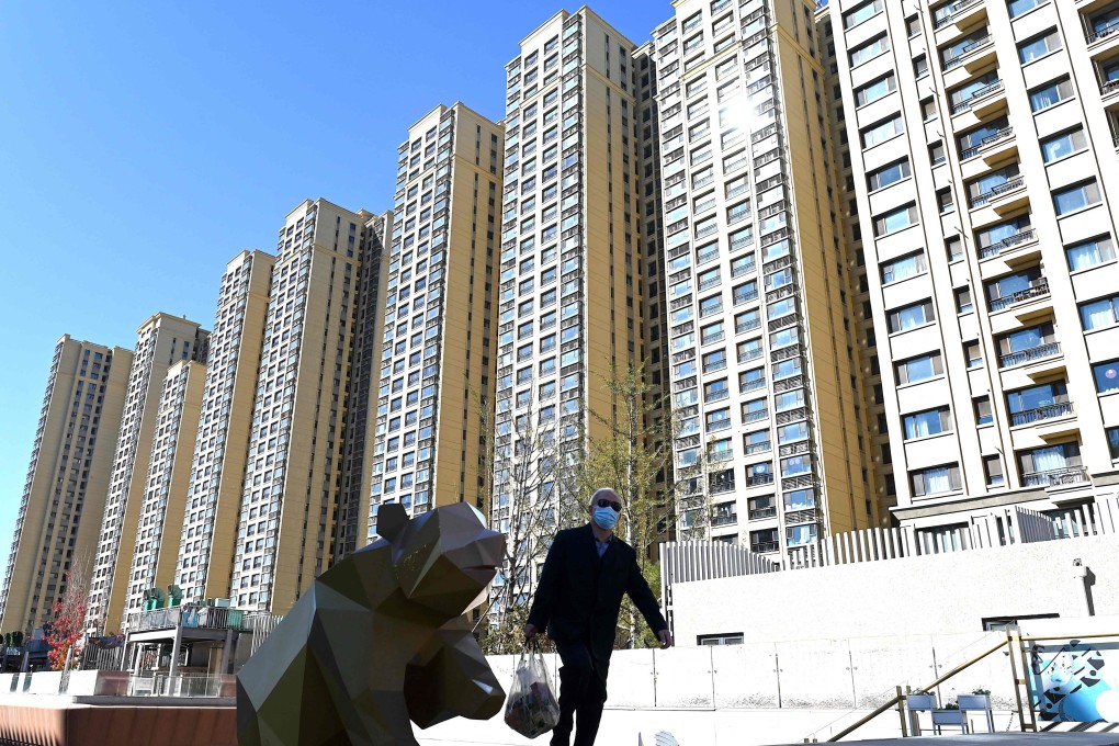 A man walks in front of a housing complex by China Evergrande in Beijing in October 2021. Photo: AFP