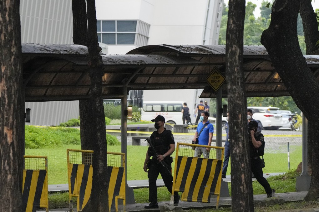 Armed police walk inside the Ateneo de Manila University campus in Quezon city, Philippines, where a gunman killed at least three people. Photo: AP