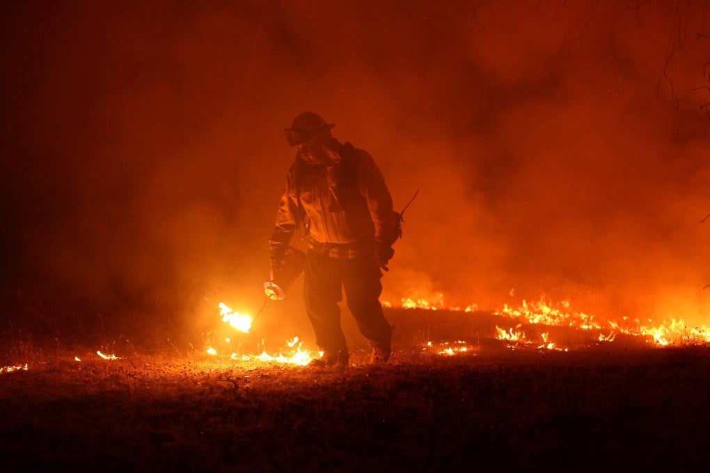 A Cal Fire firefighter battles the Oak fire near Mariposa, California on Saturday. Photo: Getty Images / TNS