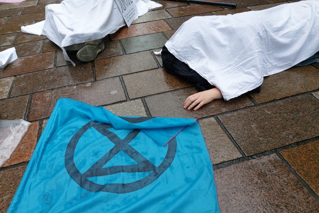 Extinction Rebellion activists stage a “die-in” protest in Glasgow’s city centre to demand action after the UK recorded its highest ever temperatures earlier this week. Photo: dpa