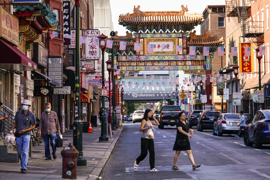 Pedestrians cross 10th Street in the Chinatown neighbourhood of Philadelphia. Organizers and members of Philadelphia’s Chinatown say they were surprised by the 76ers’ announcement that they hope to build a $1.3 billion arena just a block from the community’s gateway arch. Photo: AP