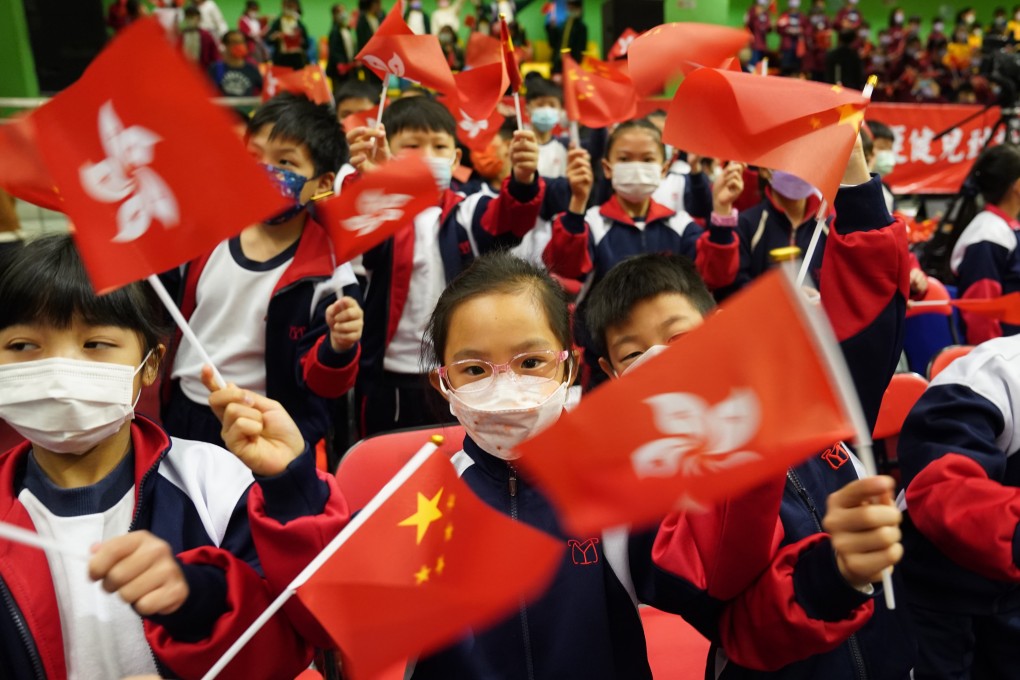 Hong Kong schoolchildren wave Chinese and city flags at a 2021 event to showcase the skills of the Chinese Olympic team at Yuen Long Sports Association. Photo: Sam Tsang.