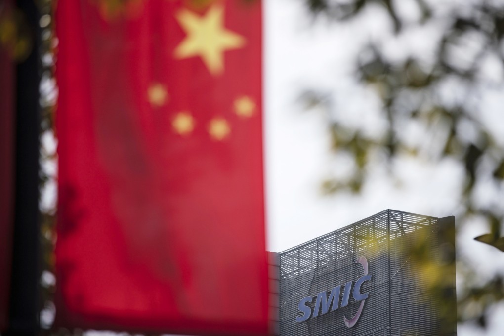 A Chinese flag near a logo atop the Semiconductor Manufacturing International Corp (SMIC) headquarters in Shanghai. Photo: Bloomberg