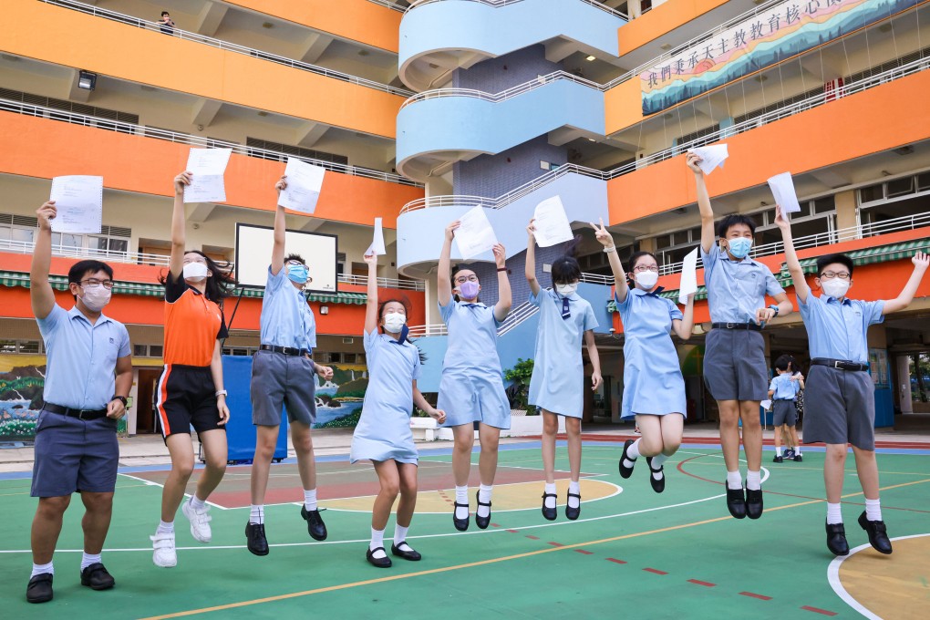 Students at Yaumati Catholic Primary School (Hoi Wang Road) jump for joy after collecting the allocation results. Photo: K. Y. Cheng