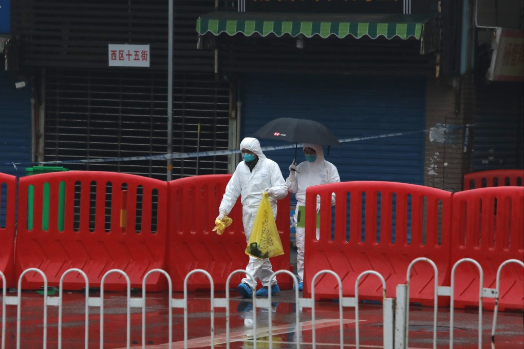 Quarantine personnel in full protective gear collect samples at  the Huanan Seafood Market  in Wuhan in January 2020. Photo: Simon Song