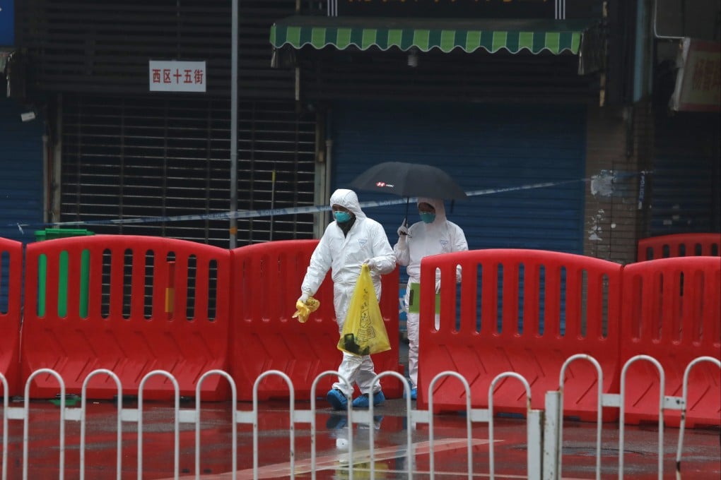 Quarantine personnel in full protective gear collect samples at the Huanan Seafood Market in Wuhan in January 2020. Photo: Simon Song