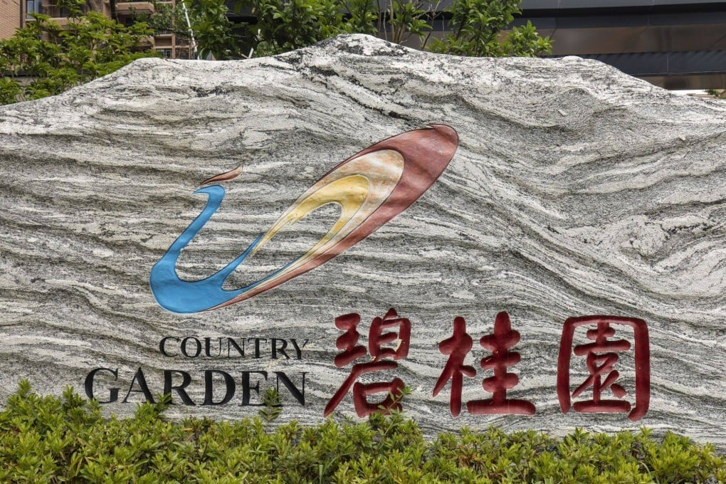 The logo for Country Garden Holdings is displayed at the company’s Fengming Haishang residential development in Shanghai, China. The company is raising US$330 million from a share sale in Hong Kong. Photo: Bloomberg