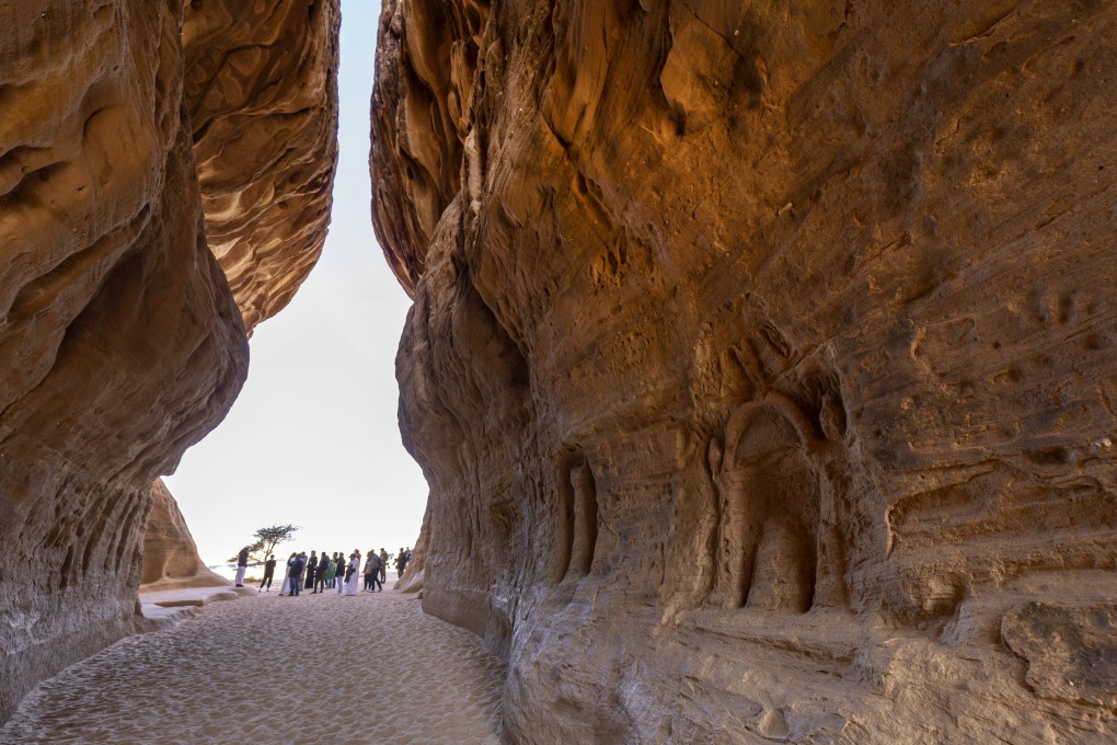 Tourists visit the Nabataean archaeological site of al-Hijr (Hegra), near the northwestern Saudi city of al-Ula. Saudi Arabia is hoping to woo visitors travelling to nearby Qatar for soccer’s World Cup. Photo: AFP