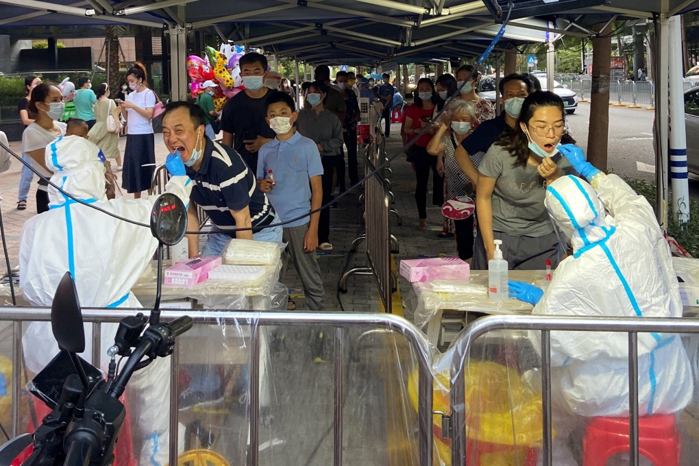 Medical workers collect swabs from residents at a Covid-19 testing site in Shenzhen on July 23. Photo: Reuters