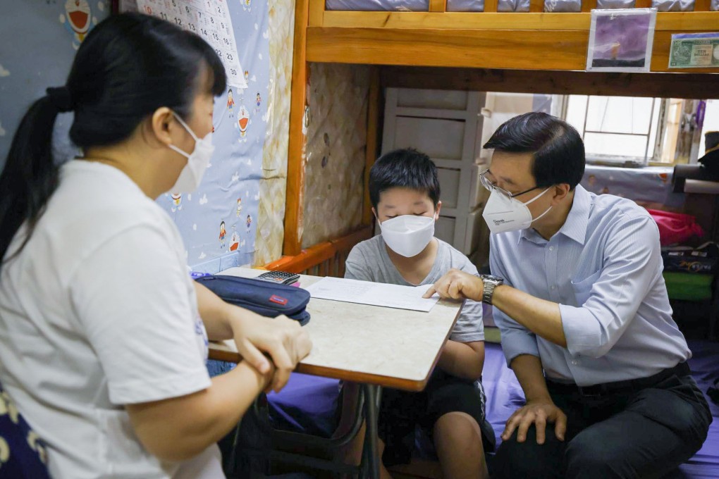 Chief Executive John Lee talks to a Form Two student, who hopes to work for the government one day, during his first district visit to Sham Shui Po. Picture: Facebook