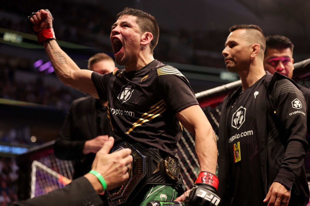 Brandon Moreno celebrates with the interim flyweight title belt after beatingKai Kara-France at UFC 277. Photo: AFP