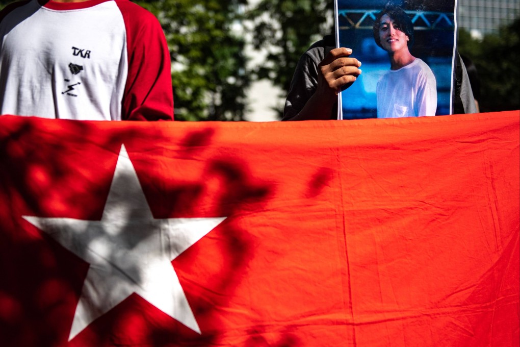 A group of activists hold placards of Japanese citizen Toru Kubota, who has been detained in Myanmar. Photo: AFP