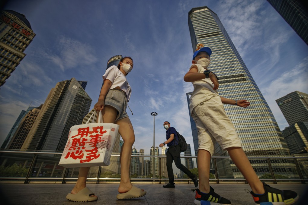 People walk in the Lujiazui financial district in Shanghai. China’s GDP grew 0.4 percent year on year in the second quarter of 2022, slowing down from 4.8 percent in the first quarter of 2022, according to data reported by the National Bureau of Statistics. Photo: EPA-EFE