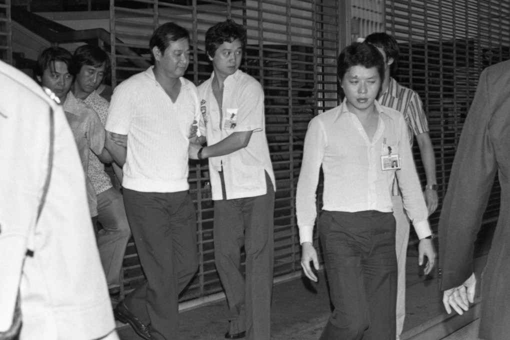 In 1979, a lone gunman in Hong Kong shot a property developer and terrorised four women hostages for five hours before he was talked into surrendering, handcuffed and taken away (above) by police. Photo: SCMP