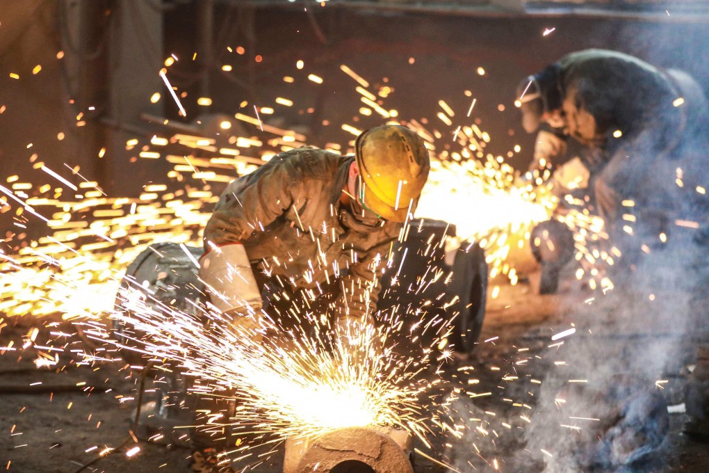 An employee works on steel casting at a foundry in Hangzhou in China’s eastern Zhejiang province. China has assigned energy reduction targets for seven sectors as it aims to reach peak emissions by 2030. Photo: AFP
