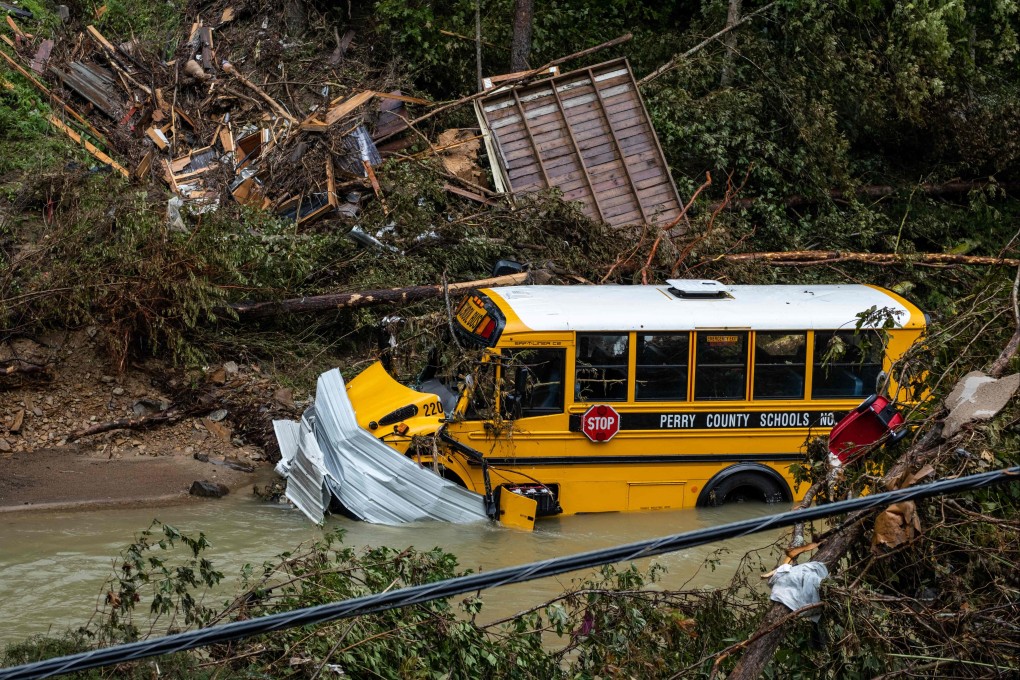 A school bus, along with other debris, sits in a creek near Jackson, Kentucky on Sunday. Photo: AFP
