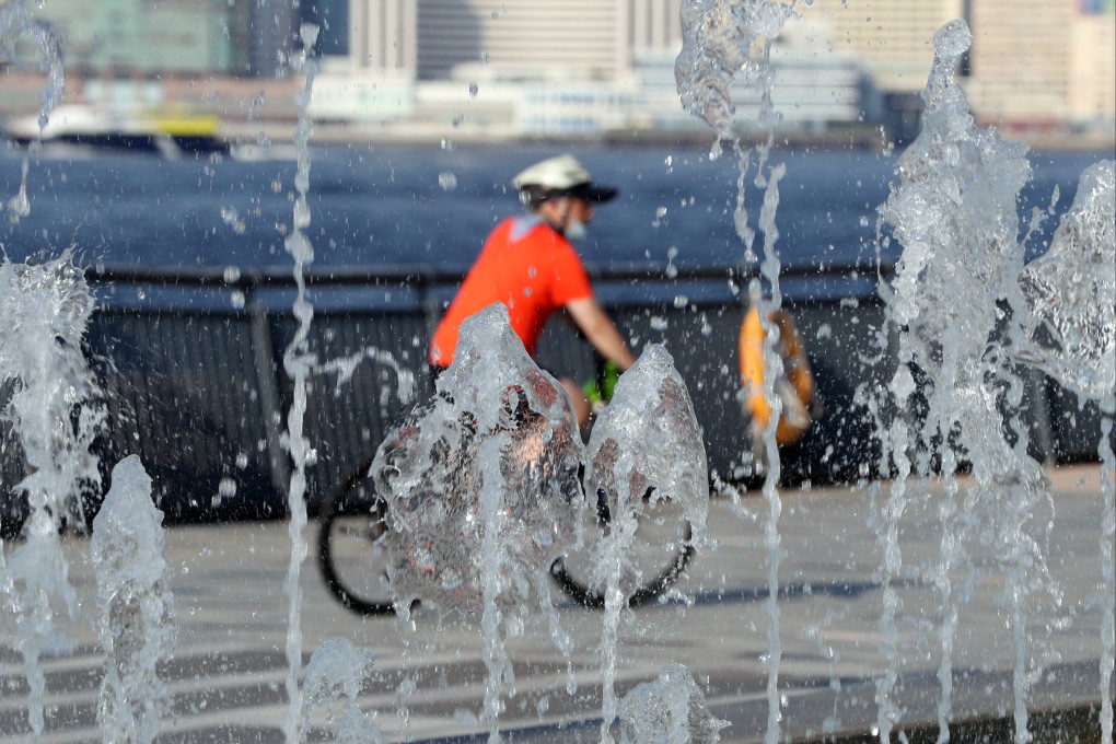 A cyclist rides past a fountain on a hot summer’s day in Hong Kong. The city registered its hottest July on record. Photo: Xinhua