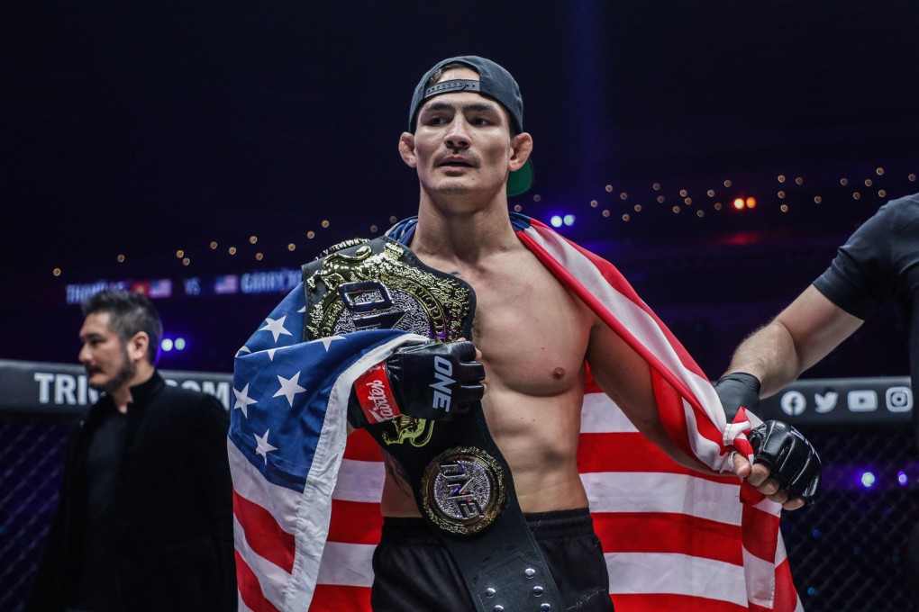 Thanh Le celebrates with his featherweight title after knocking out Garry Tonon at ONE” Lights Out.