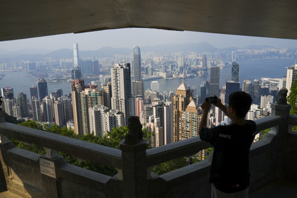 A visitor takes pictures at Lions Pavilion on Victoria Peak. Photo: Sam Tsang