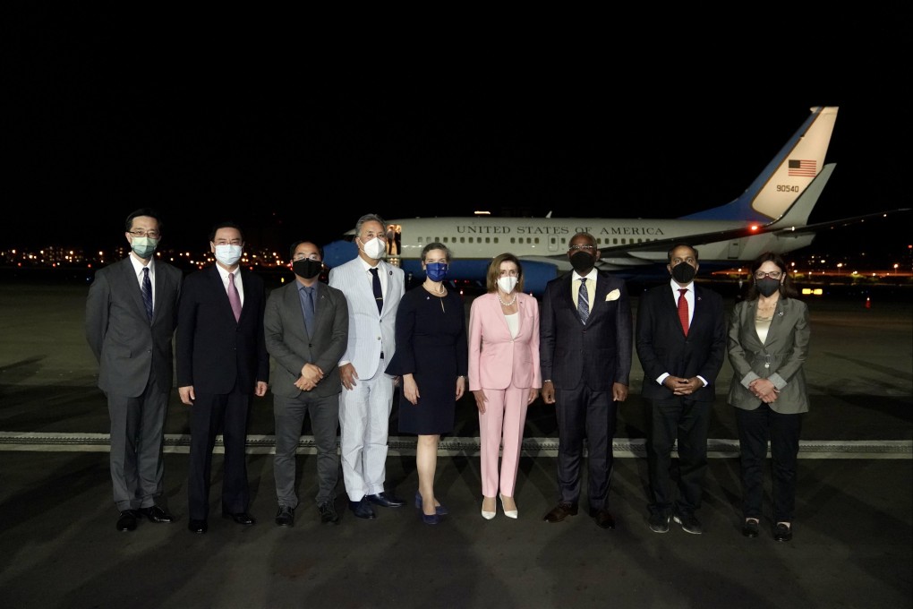 US House Speaker Nancy Pelosi (centre) poses with officials as she arrives in Taipei, Taiwan on Tuesday. Photo: EPA-EFE/Taiwan Ministry of Foreign Affairs