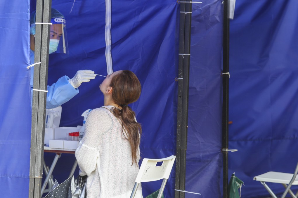 A woman gets tested for Covid-19 at a mobile specimen collection station at Victoria Park in Causeway Bay on July 19. Visitors to public hospitals are now required to get a PCR test within 48 hours of the visit. Photo: Yik Yeung-man