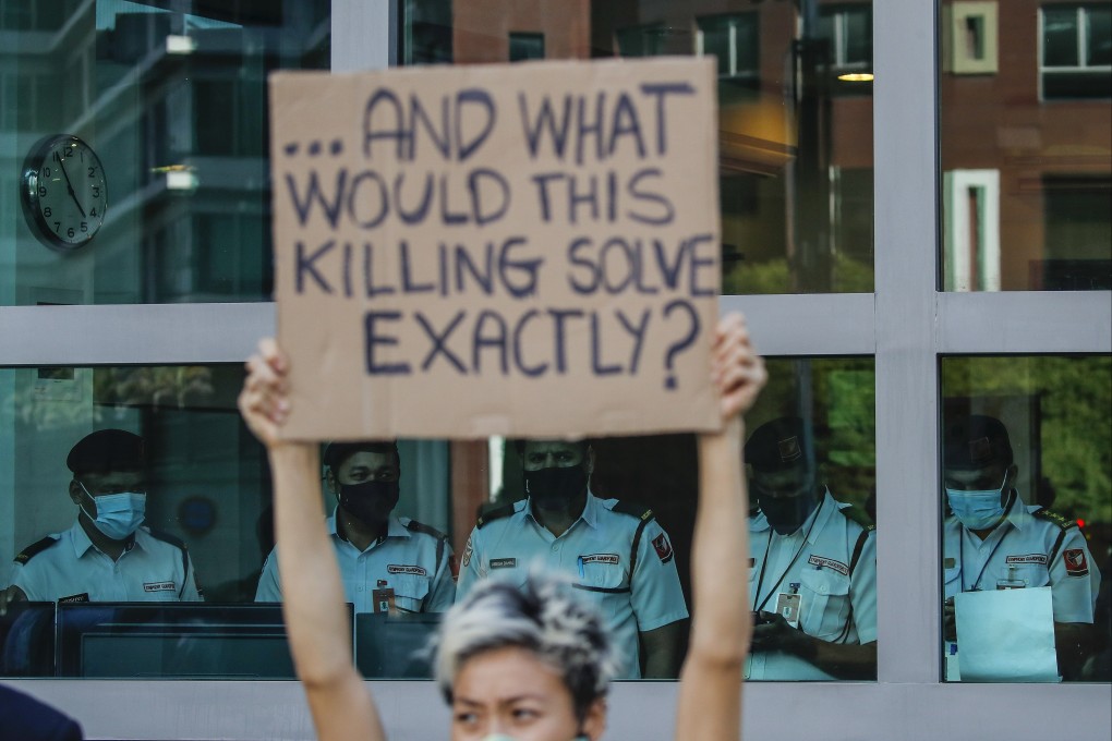 An activist holds a placard against the planned execution of a man who was convicted of a drug offence in Singapore but diagnosed as intellectually disabled. Photo: EPA-EFE