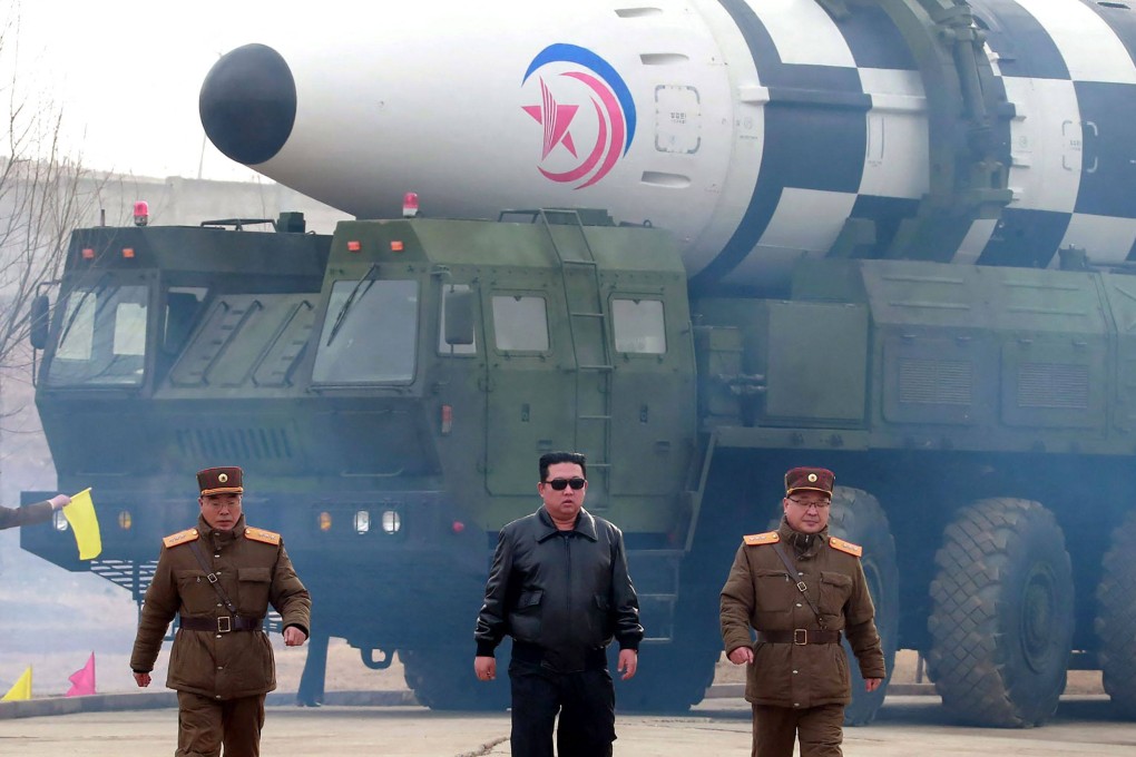 North Korean leader Kim Jong-un (C) walking near what state media report says was a new type inter-continental ballistic missile before its test launch in March this year. File photo: AFP