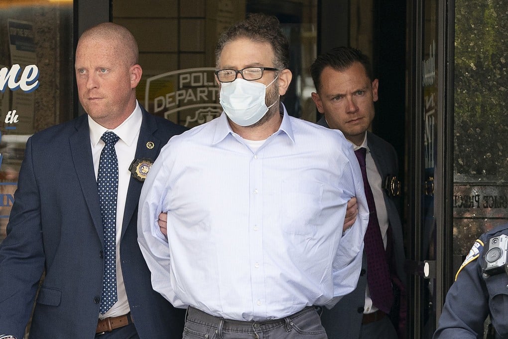 Glenn Hirsch is walked from the New York Police Department 112th Precinct station house in New York in June. Photo: New York Daily News/TNS