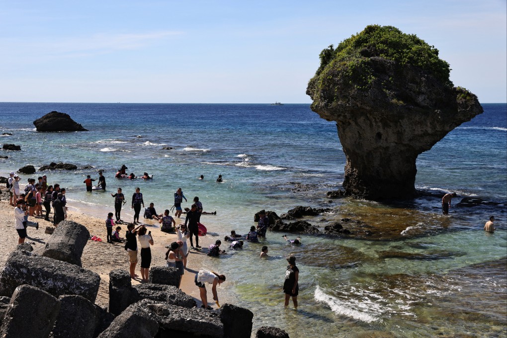Tourists and snorkelers visit a beach on Liuqiu island, a tourist spot in Taiwan known for its sea turtles. Photo: Reuters