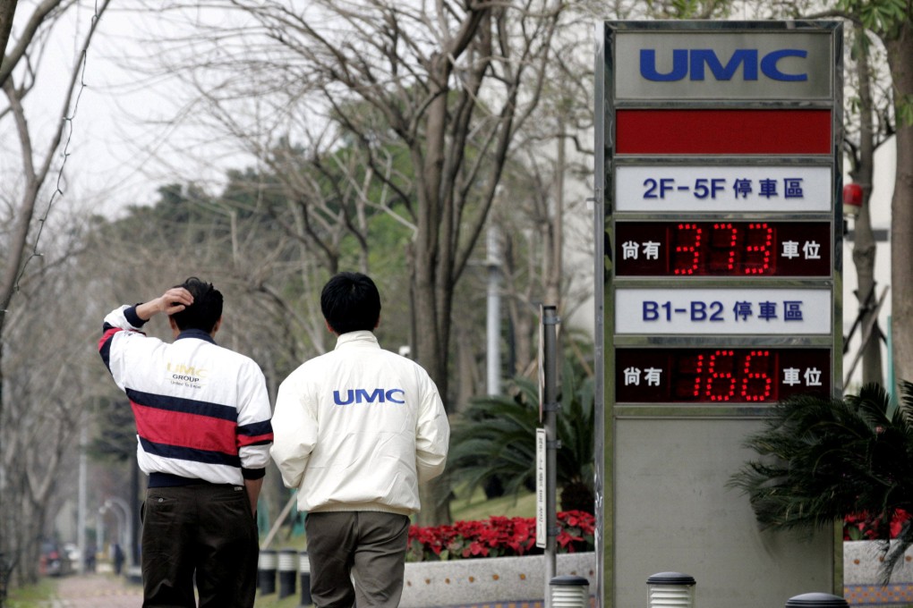 Men walk past a signboard of chip maker United Microelectronics Corp (UMC) in Hsinchu, Taiwan, on January 10, 2006. UMC has sought to distance itself from its founder after he made comments criticising mainland China’s military drills around the island following a visit by US House Speaker Nancy Pelosi. Photo: Reuters