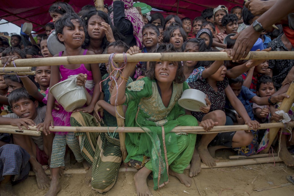 Rohingya children wait for food handouts after crossing over from Myanmar to Bangladesh as refugees in 2017. Photo: AP