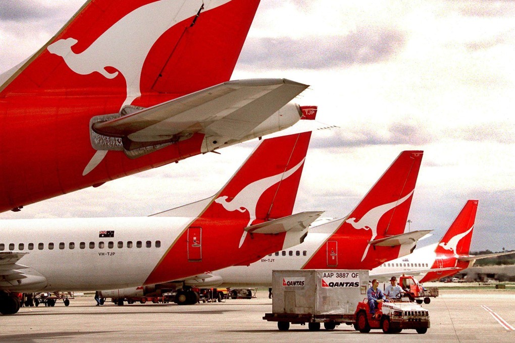 Baggage handlers drive a ground support vehicle around Qantas aircraft in Sydney. Driving the vehicles that take bags to planes and between terminals is one of the tasks the airline’s executives are being asked to cover. Photo: AFP
