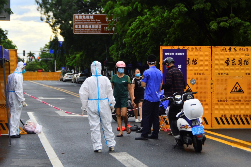 A delivery worker places food near a barricade at the entrance to a residential compound in locked-down Sanya on Monday. Photo: China Daily via Reuters