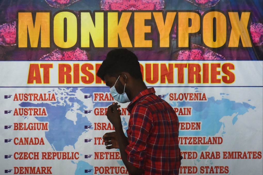 An Indian health worker walks in front of a list of ‘high-risk countries’ for the monkeypox virus in Chennai last month. Photo: EPA-EFE