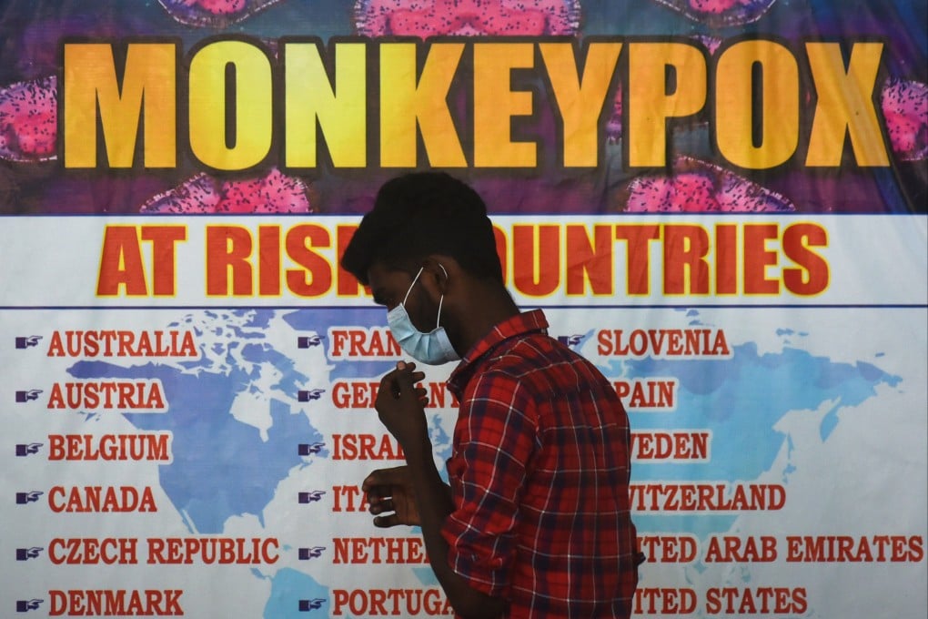 An Indian health worker walks in front of a list of ‘high-risk countries’ for the monkeypox virus in Chennai last month. Photo: EPA-EFE