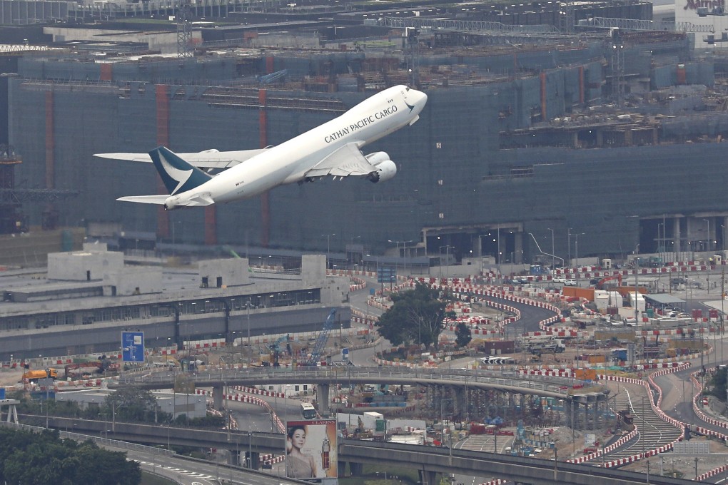 A Cathay Pacific cargo plane takes off in March 2022, above the third runway that is under construction at Chek Lap Kok. Photo: Yik Yeung-man