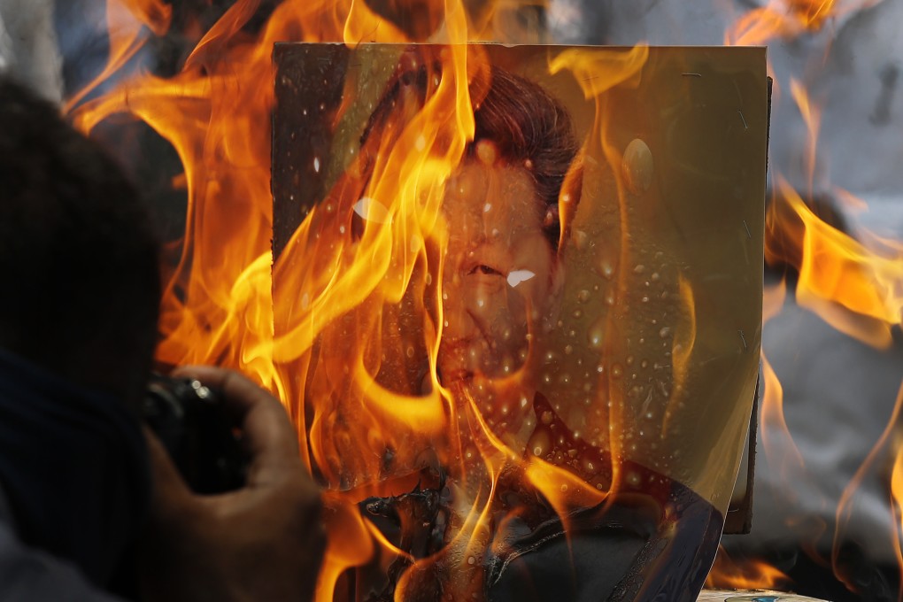Indian traders in New Delhi react to the killing of Indian soldiers in a deadly border clash in the Ladakh region in June 2020 by burning Chinese products and a poster of President Xi Jinping. Photo: AP