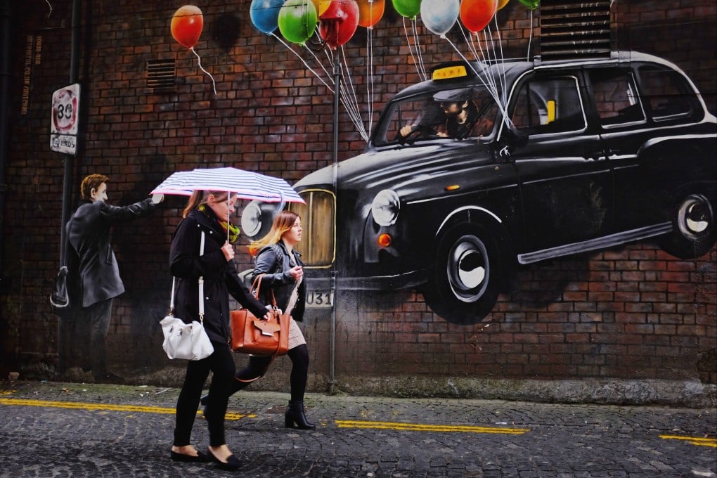 Rogue One’s famous mural shows a floating taxi with balloons tied to it. Glasgow’s murals touch on issues like climate change, social distancing, and local history. Photo: Getty Images