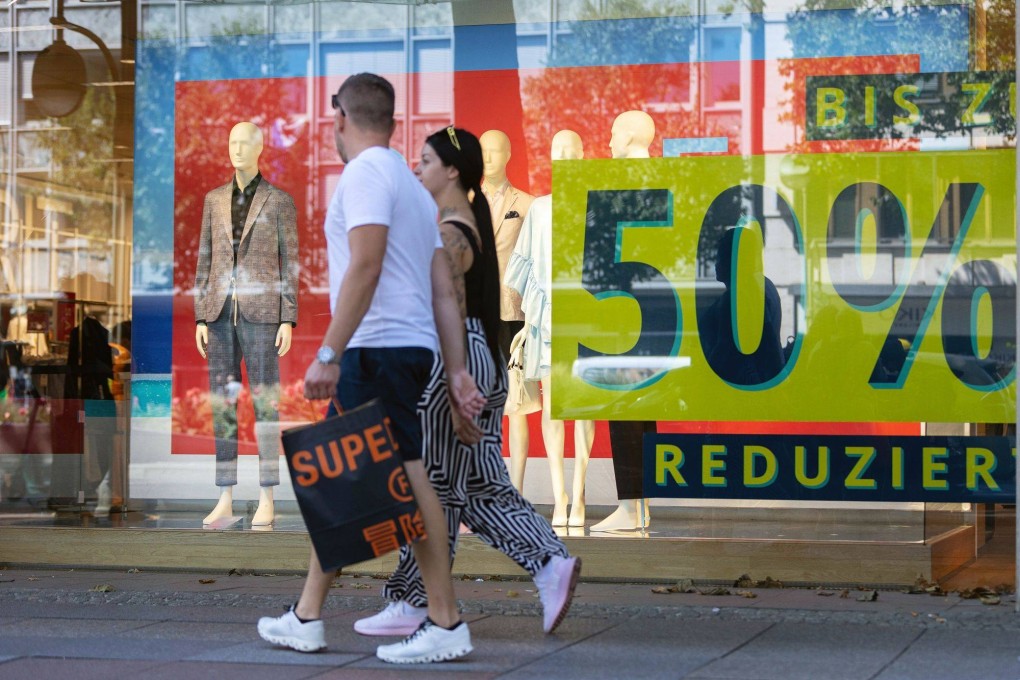 Shoppers pass a sale sign in the window of a luxury department store in Berlin, Germany, on August 9. The European Central Bank surprised markets with an aggressive interest rate hike in July, as surging energy costs saw consumer prices in the euro zone rise 8.6 per cent in June. Photo: Bloomberg