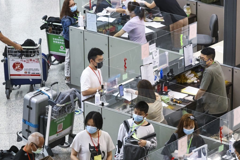 Travellers arrive at Hong Kong airport check in for transport to quarantine hotels. Photo: K. Y. Cheng