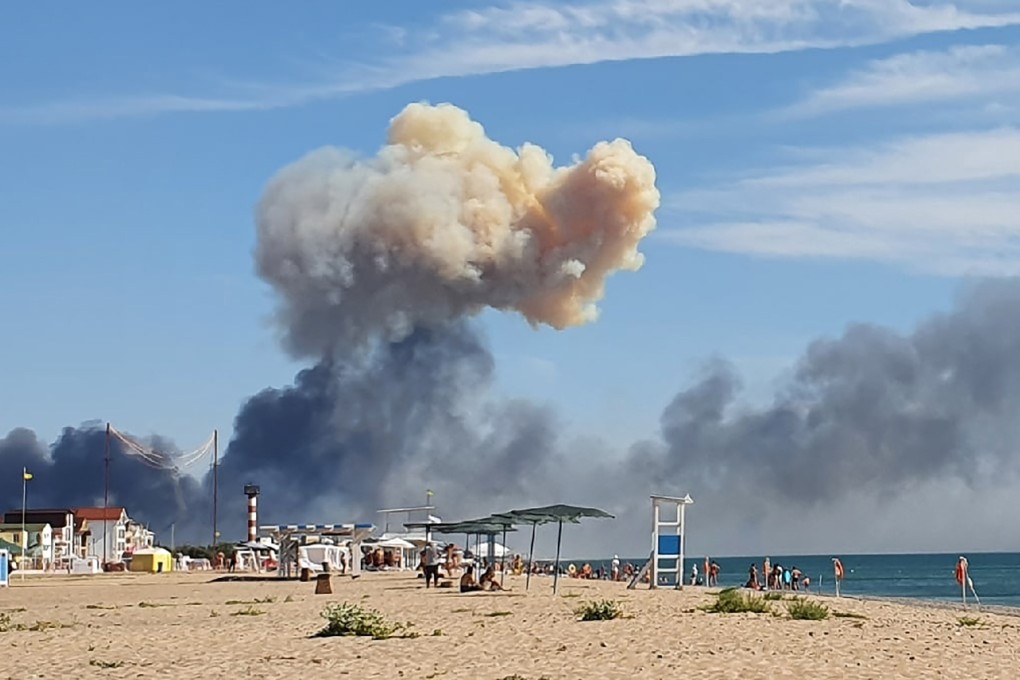 Rising smoke can be seen from the beach at Saki after explosions were heard from the direction of a Russian military airbase near Novofedorivka, Crimea on Tuesday. Photo: UGC via AP