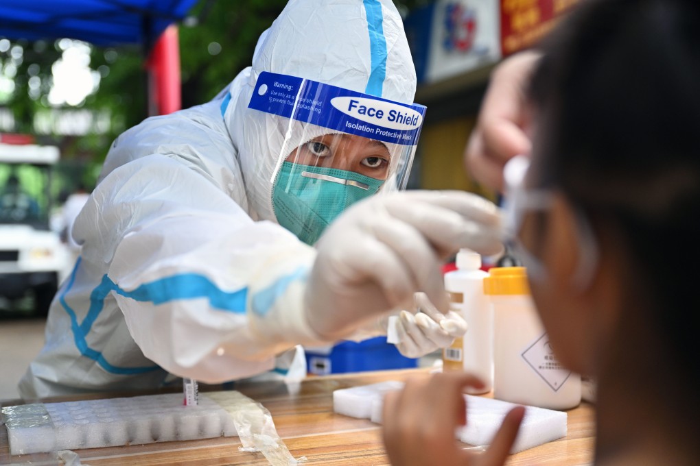 A medical worker takes a swab sample for Covid-19 testing from a person in Sanya, Hainan province, on Thursday. Photo: Xinhua