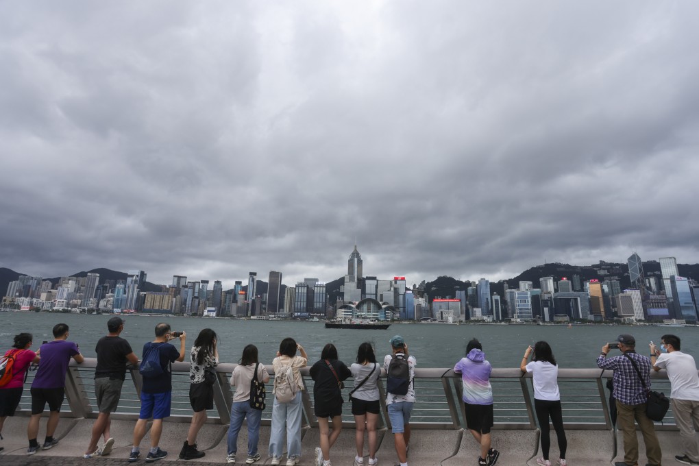 Hongkongers in Tsim Sha Tsui take photos of Victoria Harbour on the 25th anniversary of the establishment of the Hong Kong Special Administrative Region on July 1. Photo: Nora Tam