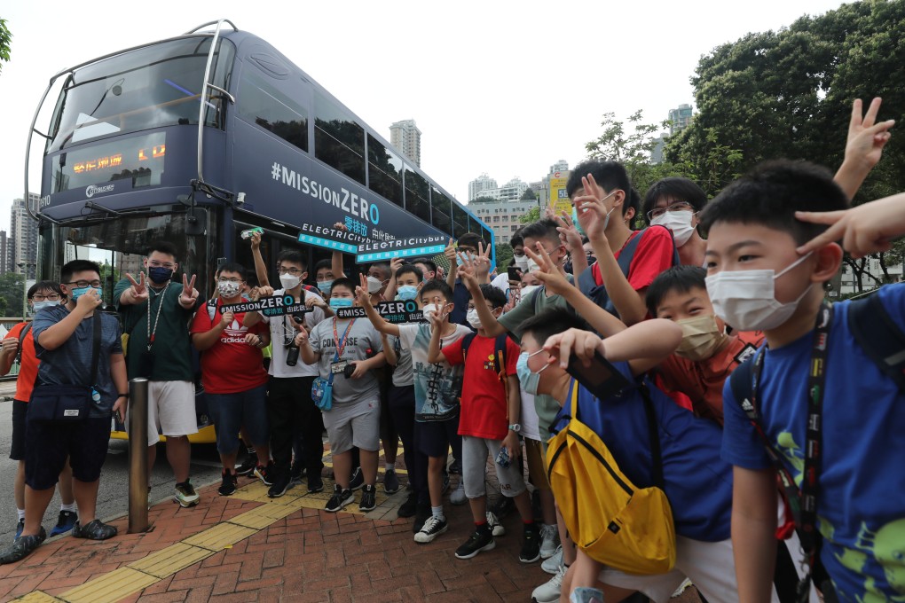 Bus fans pose for a photo while waiting to board Hong Kong’s first electric bus from Bravo Transport Services Limited in Happy Valley on June 19. Photo: Xiaomei Chen