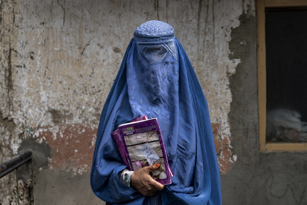 An Afghan woman leaves an underground school which she attends with her daughter, in Kabul, Afghanistan, on July 30. Photo: AP