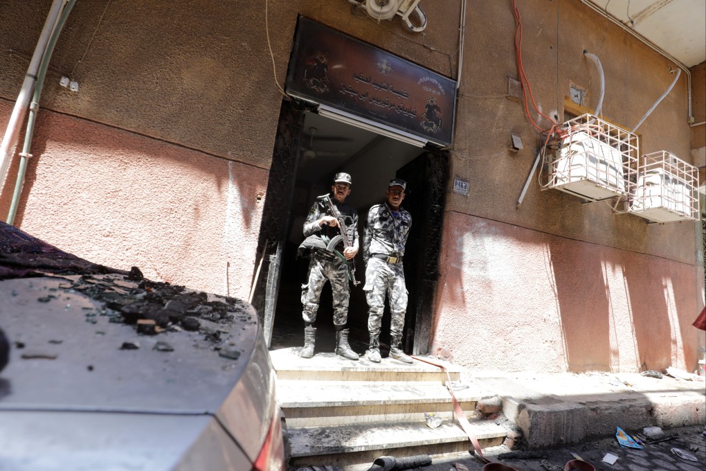 Security members stand at the scene where a deadly fire broke out at the Abu Sifine church in Egypt on August 14. Photo: Reuters